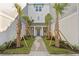 Landscaped courtyard with brick pavers and palm trees between the townhouses at 208 W Frances Ave # 1, Tampa, FL 33602