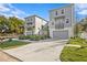 Front view of two townhouses with gray siding, attached garages, and a paved driveway at 208 W Frances Ave # 1, Tampa, FL 33602