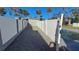 Side yard with gravel pathway and white vinyl fence at 4310 Huntington Ne St, St Petersburg, FL 33703