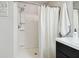 Bathroom featuring a shower with white shower curtain and chrome shower head with an adjacent sink at 3314 San Moise Pl, Plant City, FL 33567