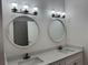 Spacious bathroom with double vanity and round mirrors at 37570 Teri Ct, Dade City, FL 33525