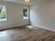 Spacious bedroom with wood-look floors and large windows at 37570 Teri Ct, Dade City, FL 33525