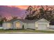 House exterior at dusk showcasing stone and light-colored siding at 37570 Teri Ct, Dade City, FL 33525