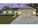 Charming house exterior featuring a two-car garage and stone accents at 37570 Teri Ct, Dade City, FL 33525