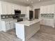 Modern kitchen with white cabinets and large island at 37570 Teri Ct, Dade City, FL 33525