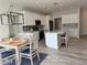 Modern kitchen with white cabinets, a center island, and wood floors at 37570 Teri Ct, Dade City, FL 33525