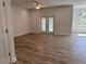 Bright living room with wood-look floors and sliding glass doors at 37570 Teri Ct, Dade City, FL 33525