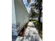 Side yard with a paved walkway and neatly landscaped greenery at 37570 Teri Ct, Dade City, FL 33525