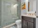 Modern bathroom with a glass shower, dark vanity, and mosaic tile floor at 4114 W Zelar St, Tampa, FL 33629