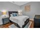 Cozy bedroom with dark wood platform bed and two nightstands at 4114 W Zelar St, Tampa, FL 33629