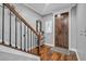 Elegant entryway with hardwood floors, staircase, and a wood door at 4114 W Zelar St, Tampa, FL 33629