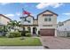 Two-story house with a brown door and brick driveway at 4114 W Zelar St, Tampa, FL 33629