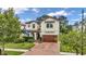 Two-story house with a brown door and brick driveway at 4114 W Zelar St, Tampa, FL 33629