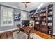 Home office with built-in bookcase, hardwood floors, and a large desk at 4114 W Zelar St, Tampa, FL 33629