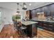 Modern kitchen with large island, stainless steel appliances, and hardwood floors at 4114 W Zelar St, Tampa, FL 33629