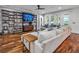 Spacious living room with hardwood floors, large sectional sofa, and built-in shelving at 4114 W Zelar St, Tampa, FL 33629