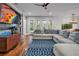 Light-filled living room with hardwood floors, sectional sofa, and a large TV at 4114 W Zelar St, Tampa, FL 33629