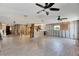 Spacious living room featuring tile floors, ceiling fans, and exposed framework for remodeling at 13930 King Ave, Hudson, FL 34667