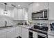 Modern kitchen features stainless steel appliances and white shaker cabinets at 12020 82Nd E St, Parrish, FL 34219
