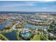Aerial view of community with lake and houses at 13204 Waterleaf Garden Cir, Riverview, FL 33579