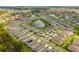 Aerial view of community with lake and numerous houses at 13204 Waterleaf Garden Cir, Riverview, FL 33579