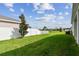 Fenced backyard with grassy lawn and a mature tree at 13204 Waterleaf Garden Cir, Riverview, FL 33579