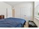 Bedroom with a double bed, dresser, and double doors at 13204 Waterleaf Garden Cir, Riverview, FL 33579