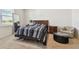 Bright bedroom with a double bed, nightstand and chair at 13204 Waterleaf Garden Cir, Riverview, FL 33579