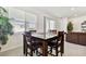 Bright breakfast nook with a wooden table and four chairs at 13204 Waterleaf Garden Cir, Riverview, FL 33579