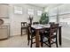 Bright breakfast nook with a wooden table and four chairs at 13204 Waterleaf Garden Cir, Riverview, FL 33579