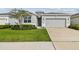 One-story home with gray siding and two-car garage at 13204 Waterleaf Garden Cir, Riverview, FL 33579