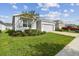 One-story home with gray siding and two-car garage at 13204 Waterleaf Garden Cir, Riverview, FL 33579