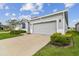 One-story home with gray siding and two-car garage at 13204 Waterleaf Garden Cir, Riverview, FL 33579