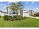 One-story home with gray siding and two-car garage at 13204 Waterleaf Garden Cir, Riverview, FL 33579