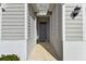Front entry with gray door and stone accents at 13204 Waterleaf Garden Cir, Riverview, FL 33579