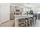 Kitchen island with seating and gray cabinets, open to dining area at 13204 Waterleaf Garden Cir, Riverview, FL 33579