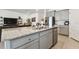 Granite kitchen island with sink and stainless steel dishwasher at 13204 Waterleaf Garden Cir, Riverview, FL 33579