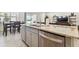 Kitchen island with granite countertop, sink, and stainless steel appliances at 13204 Waterleaf Garden Cir, Riverview, FL 33579
