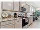 Kitchen with gray cabinets, granite countertops, and stainless steel appliances at 13204 Waterleaf Garden Cir, Riverview, FL 33579