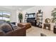 Spacious living room with sectional sofa and large TV at 13204 Waterleaf Garden Cir, Riverview, FL 33579