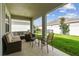 Relaxing covered patio, outdoor seating, and yard view at 13204 Waterleaf Garden Cir, Riverview, FL 33579