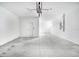 Spacious and clean garage, featuring white walls and concrete flooring at 4658 Freccia Loop, Wesley Chapel, FL 33543