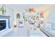 Open concept living room featuring a fireplace, comfortable seating and access to a modern kitchen at 2618 Gulf Blvd # 407, Indian Rocks Beach, FL 33785