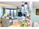 Bright living room with ocean view balcony, fireplace, comfortable seating, ceiling fan and modern lighting at 2618 Gulf Blvd # 407, Indian Rocks Beach, FL 33785