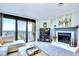 Cozy living room featuring a fireplace, television, comfortable seating, and an ocean-view balcony at 2618 Gulf Blvd # 407, Indian Rocks Beach, FL 33785