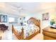 Well-lit main bedroom with a large decorative headboard and tile flooring at 2618 Gulf Blvd # 407, Indian Rocks Beach, FL 33785
