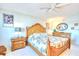 Well-lit main bedroom featuring a large decorative bedframe and tile flooring at 2618 Gulf Blvd # 407, Indian Rocks Beach, FL 33785