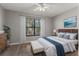 Spacious bedroom with wood-look floors and large window at 1662 Seascape Cir # 205, Tarpon Springs, FL 34689