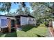 Brick grill and expansive backyard with lush lawn at 1802 E Hamilton Ave, Tampa, FL 33610