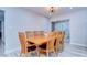 Bright dining room with large wood table and six chairs at 1802 E Hamilton Ave, Tampa, FL 33610